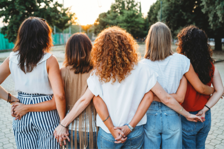Group of 5 women with their backs to the camera holding hands Mental Health and Wellbeing
