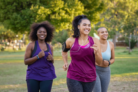 Three women jogging in a park showing social support